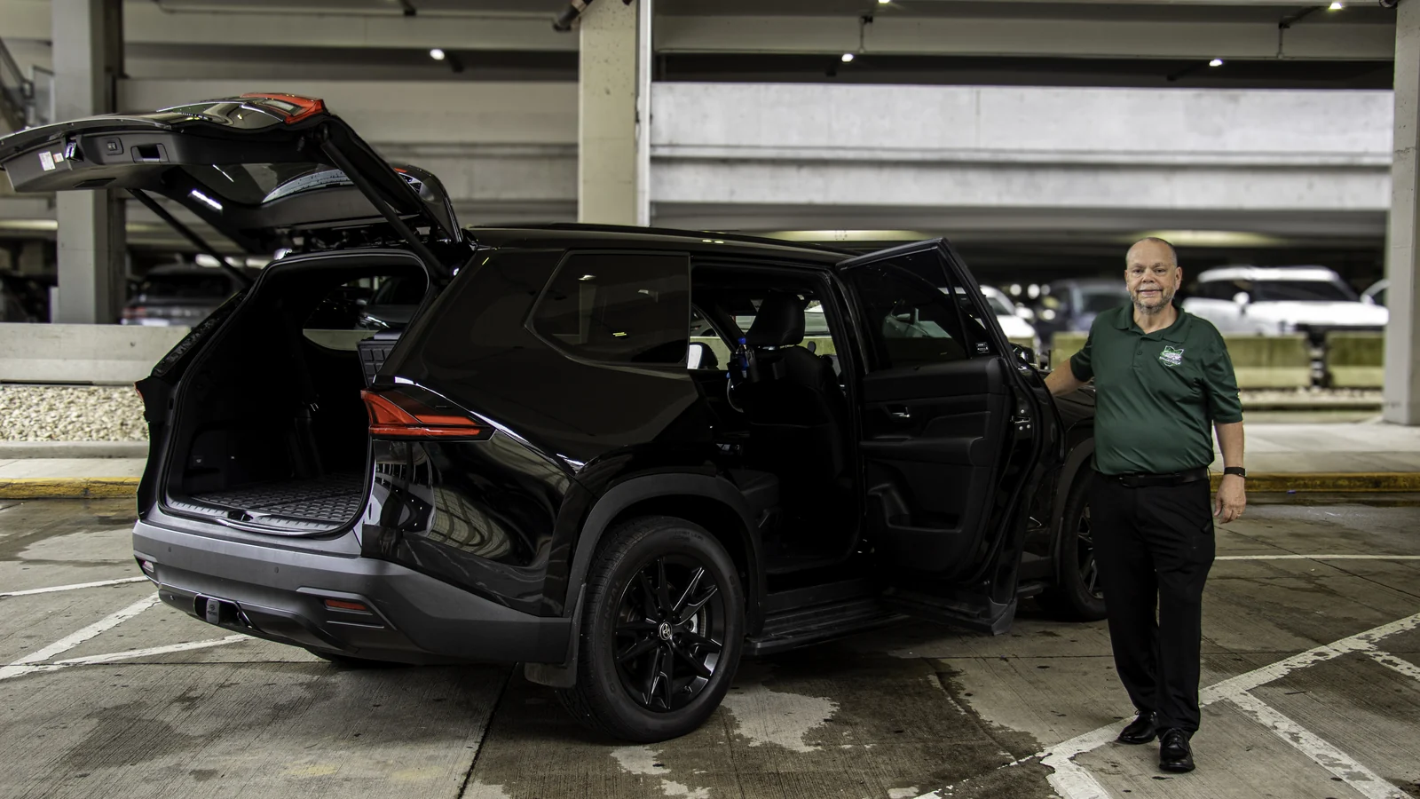 Steve beside the Smart Ride Toyota Grand Highlander with its passenger door and cargo hatch open